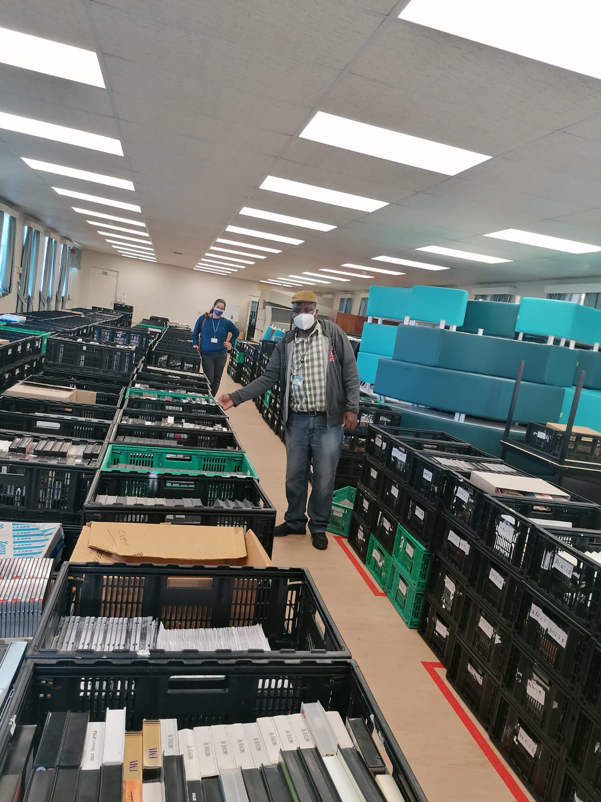 Principal Archivist, Michal Singer, and Archivist, Isaac Ntabankulu, inspect the salvaged Audiovisual Archive.