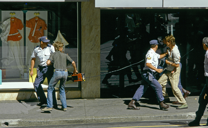 Cameraman Craig Matthews and his soundman, who were filming anti-apartheid protests in Cape Town, are arrested by police with orders to prevent media coverage of the unrest, October 1985, Cape Town, South Africa. 